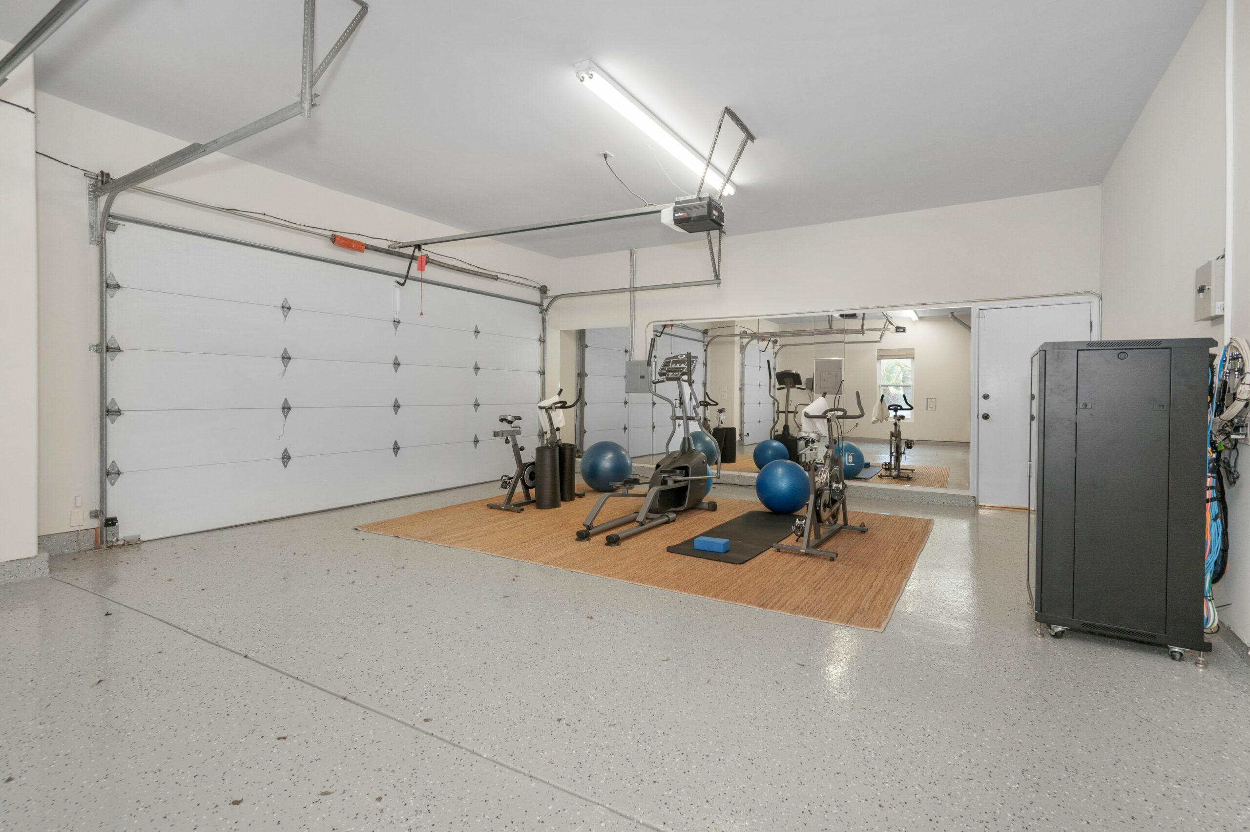 a room with exercise equipment and exercise balls